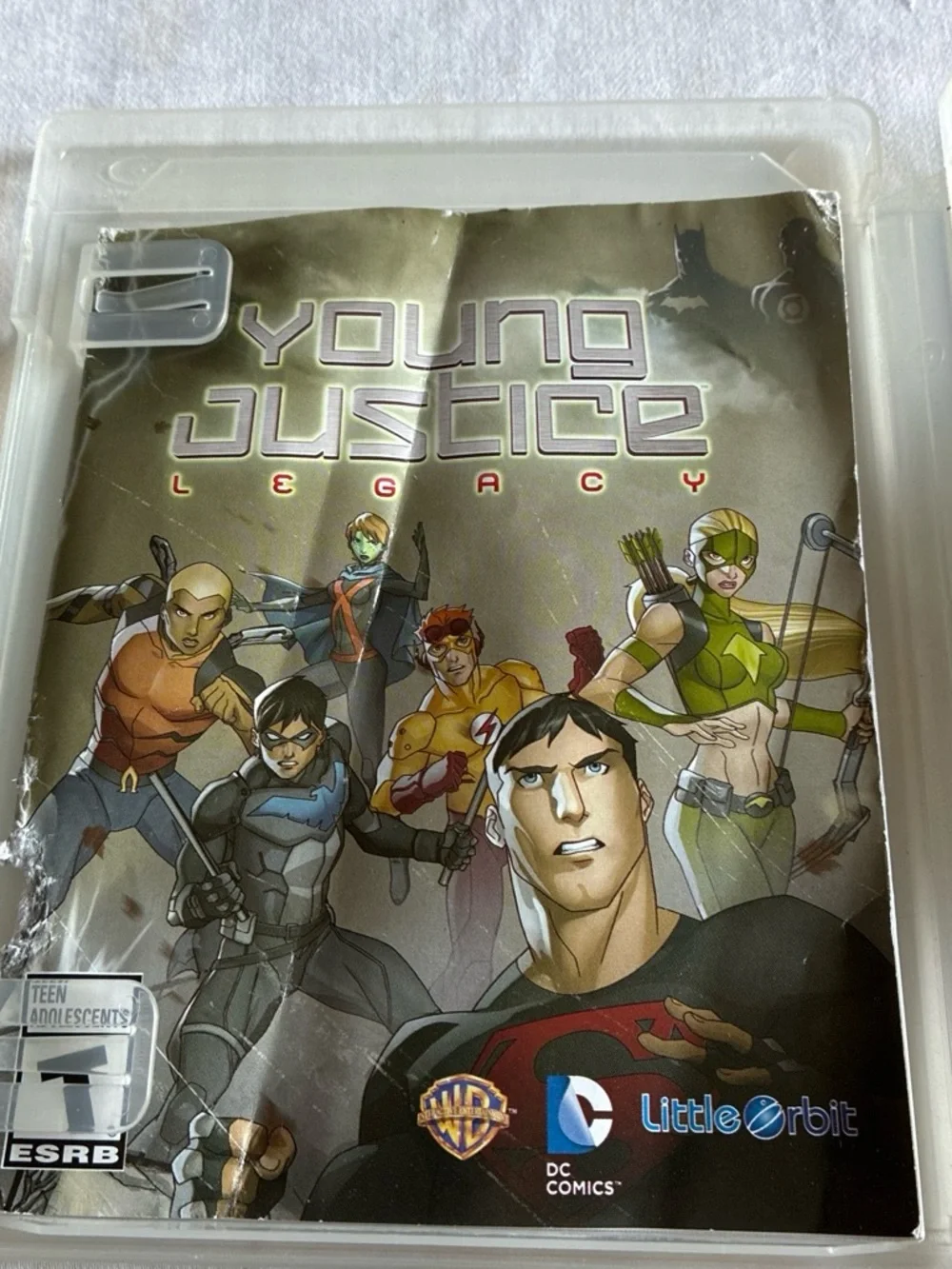 Justice Young Justice Legacy PS3 Game Cover — Green, Black, Gray, Blue
